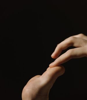 Close-up of hands in a meditative gesture.